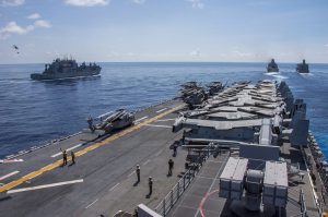 161003-N-TH560-391 HONG KONG (Oct. 3, 2016) Lewis and Clark-class dry cargo ship USNS Washington Chambers (T-AKE 11), left, conducts a vertical replenishment (VERTREP) with amphibious assault ship USS Bonhomme Richard (LHD 6), while amphibious transport dock ship USS Green Bay (LPD 20) conducts a fueling at sea with Military Sealift Command fleet replenishment oiler USNS Walter S. Diehl (T-AO 193). Bonhomme Richard, flagship of the Bonhomme Richard Expeditionary Strike Group, is operating in the South China Sea in support of security and stability in the Indo-Asia Pacific region. (U.S. Navy photo by Petty Officer 3rd Class Jeanette Mullinax/Released)